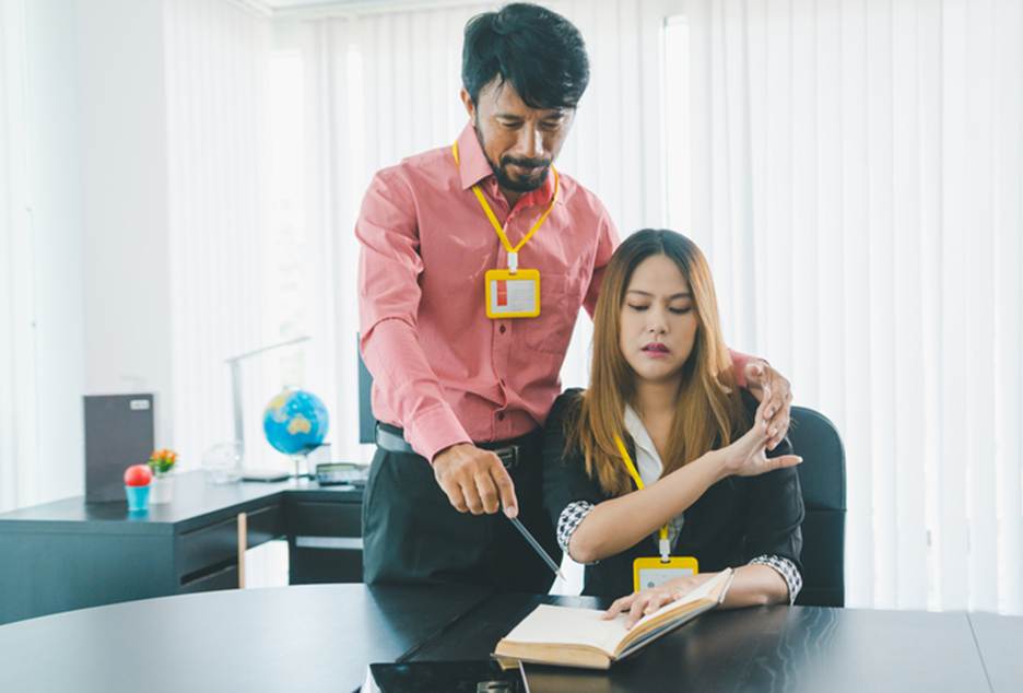Female pushing male coworkers hand off of her - Sexual Discrimination